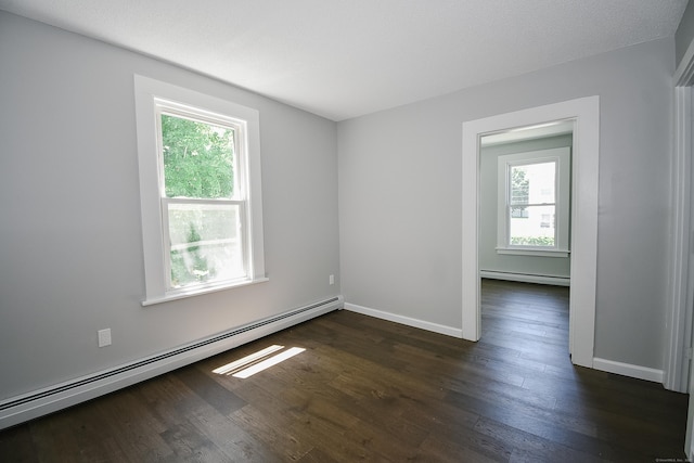 31 Chapman St, New Britain, CT 06051 - spare room with a baseboard heating unit, plenty of natural light, and dark wood-type flooring