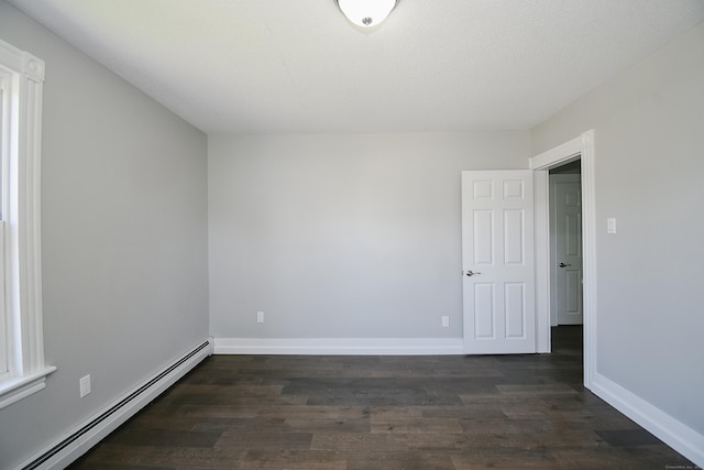 31 Chapman St, New Britain, CT 06051 - unfurnished room with baseboard heating and dark wood-style flooring