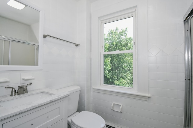 31 Chapman St, New Britain, CT 06051 - bathroom featuring tile walls, plenty of natural light, vanity, and a shower with door