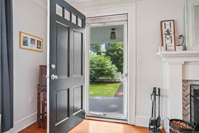 2 Clearview Ave, Norwalk, CT 06851 - foyer with wood finished floors, a fireplace, and crown molding