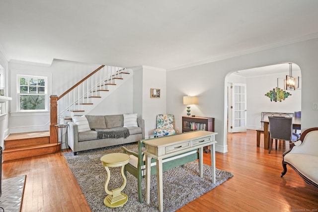 2 Clearview Ave, Norwalk, CT 06851 - living area with hardwood / wood-style flooring, arched walkways, stairway, crown molding, and a chandelier