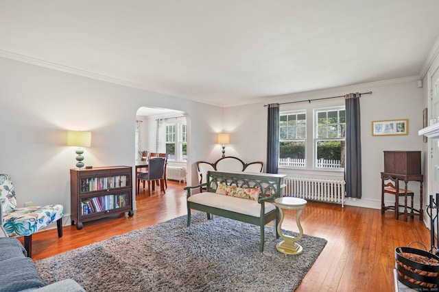 2 Clearview Ave, Norwalk, CT 06851 - living area with radiator, arched walkways, ornamental molding, and wood-type flooring