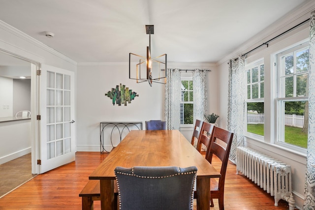 2 Clearview Ave, Norwalk, CT 06851 - dining space featuring radiator heating unit, wood finished floors, ornamental molding, and a chandelier