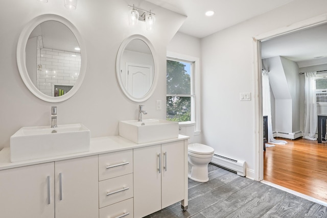 2 Clearview Ave, Norwalk, CT 06851 - bathroom with a baseboard radiator, double vanity, wood finished floors, and recessed lighting