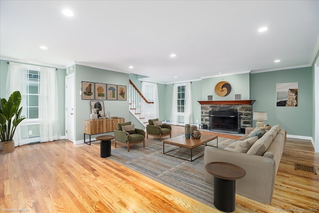 1384 N Benson Rd, Fairfield, CT 06824 - living area with stairs, ornamental molding, recessed lighting, a fireplace, and wood finished floors