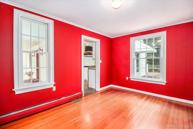 1384 N Benson Rd, Fairfield, CT 06824 - spare room featuring a baseboard heating unit, light wood-style flooring, and ornamental molding