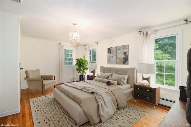 1384 N Benson Rd, Fairfield, CT 06824 - bedroom with a baseboard radiator, a chandelier, and light wood-style floors