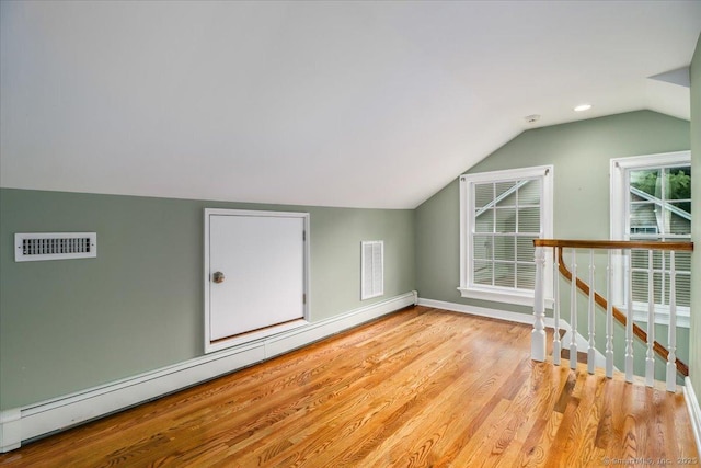 1384 N Benson Rd, Fairfield, CT 06824 - bonus room with a baseboard radiator, lofted ceiling, and light wood finished floors