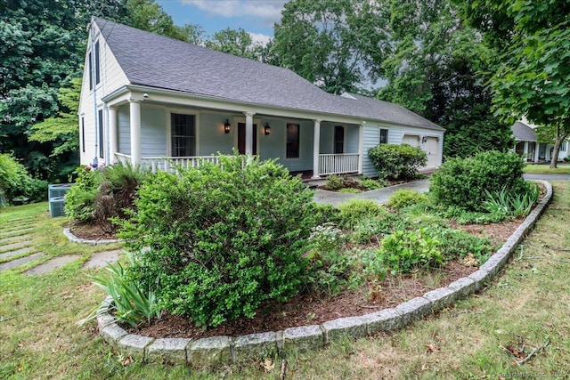 1384 N Benson Rd, Fairfield, CT 06824 - view of front of property featuring covered porch, roof with shingles, a garage, and a front lawn