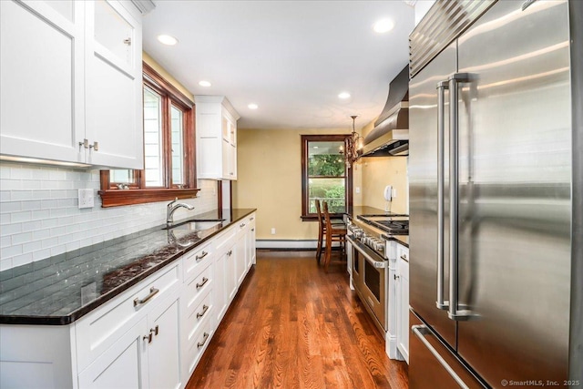 1384 N Benson Rd, Fairfield, CT 06824 - kitchen with premium appliances, wall chimney range hood, recessed lighting, a baseboard radiator, and dark wood-style floors