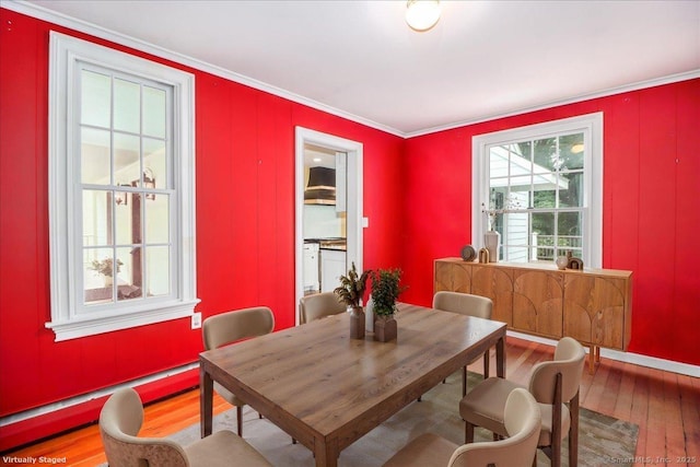 1384 N Benson Rd, Fairfield, CT 06824 - dining space featuring a baseboard radiator, hardwood / wood-style flooring, and crown molding