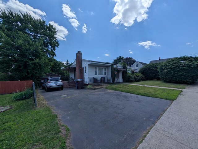 56 Mitchell St, New Britain, CT 06053 - view of front of house with a chimney and driveway