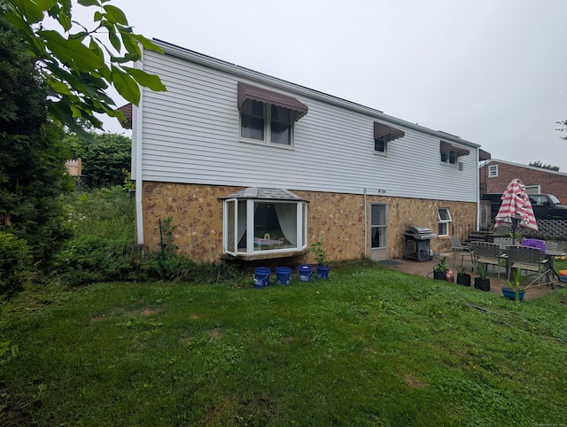 56 Mitchell St, New Britain, CT 06053 - back of house with a yard and a patio