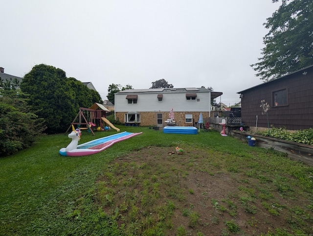 56 Mitchell St, New Britain, CT 06053 - rear view of house featuring a playground and a yard