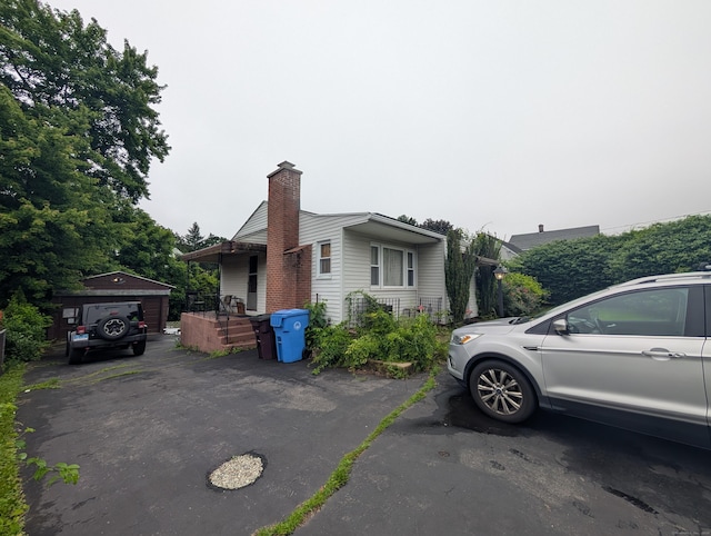 56 Mitchell St, New Britain, CT 06053 - view of front of home with a chimney and an outdoor structure