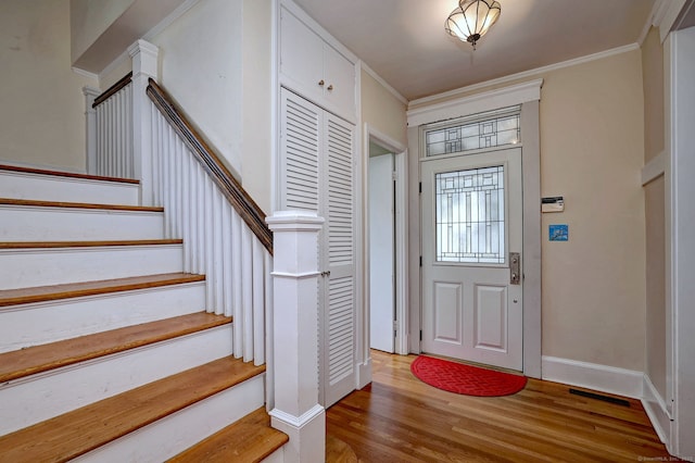 150 Westwood Rd, New Haven, CT 06515 - entryway featuring light wood-style floors, stairs, and ornamental molding