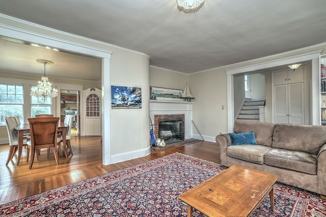 150 Westwood Rd, New Haven, CT 06515 - living area with a chandelier, stairway, wood finished floors, a brick fireplace, and ornamental molding