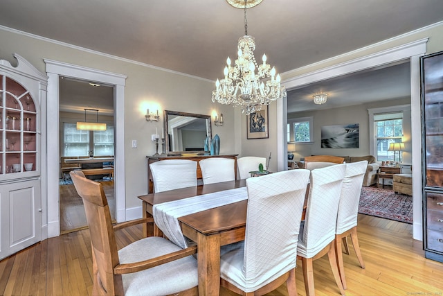 150 Westwood Rd, New Haven, CT 06515 - dining area featuring light wood-style floors, a chandelier, and crown molding