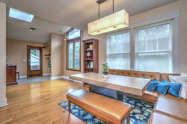 150 Westwood Rd, New Haven, CT 06515 - dining area with healthy amount of natural light, a skylight, light wood finished floors, and lofted ceiling