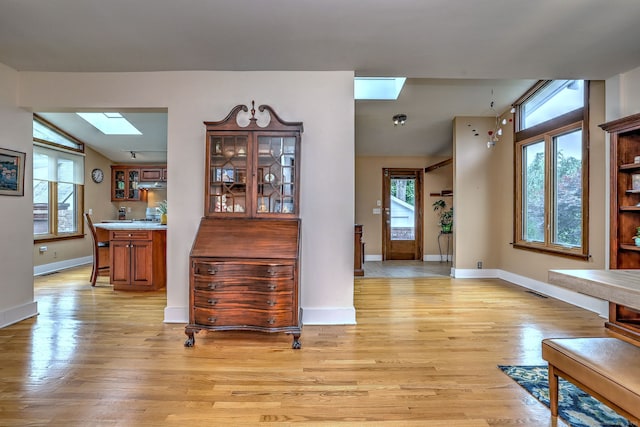 150 Westwood Rd, New Haven, CT 06515 - foyer entrance featuring a skylight, vaulted ceiling, healthy amount of natural light, and light wood finished floors