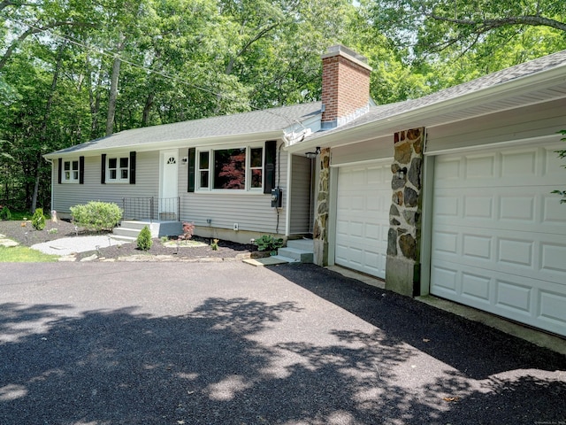 185 Hope Valley Rd, Hebron, CT 06231 - single story home with a chimney, driveway, an attached garage, a shingled roof, and stone siding