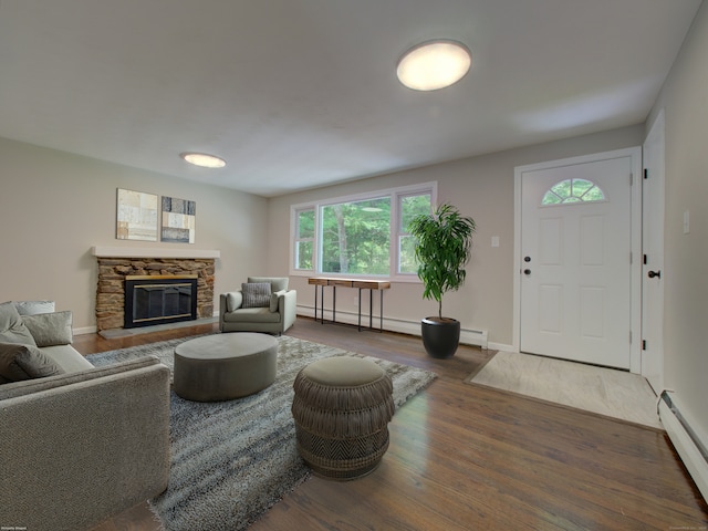 185 Hope Valley Rd, Hebron, CT 06231 - living room with a baseboard heating unit, wood finished floors, a fireplace, and baseboard heating