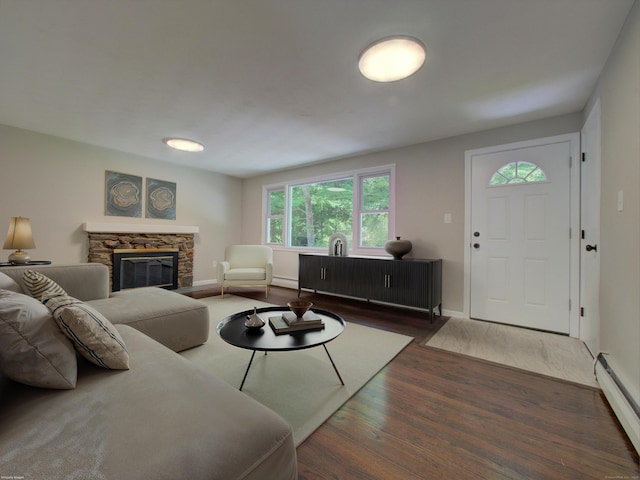 185 Hope Valley Rd, Hebron, CT 06231 - living area with a baseboard heating unit, wood finished floors, and a stone fireplace