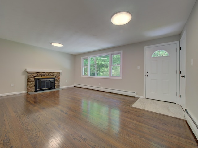185 Hope Valley Rd, Hebron, CT 06231 - unfurnished living room with baseboard heating, a baseboard radiator, wood finished floors, and a fireplace
