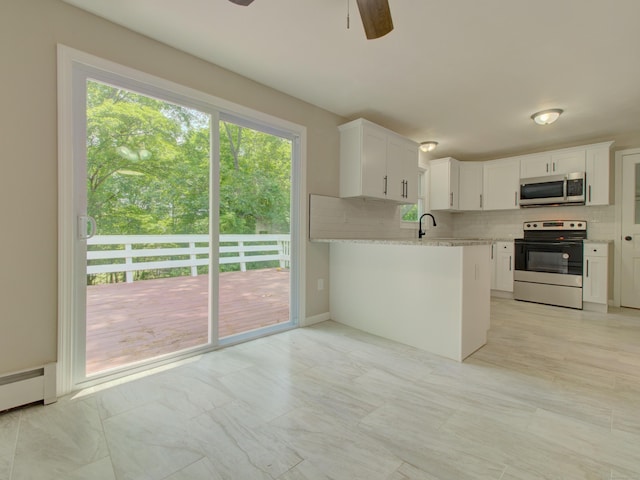 185 Hope Valley Rd, Hebron, CT 06231 - kitchen with stainless steel appliances, a ceiling fan, decorative backsplash, and healthy amount of natural light