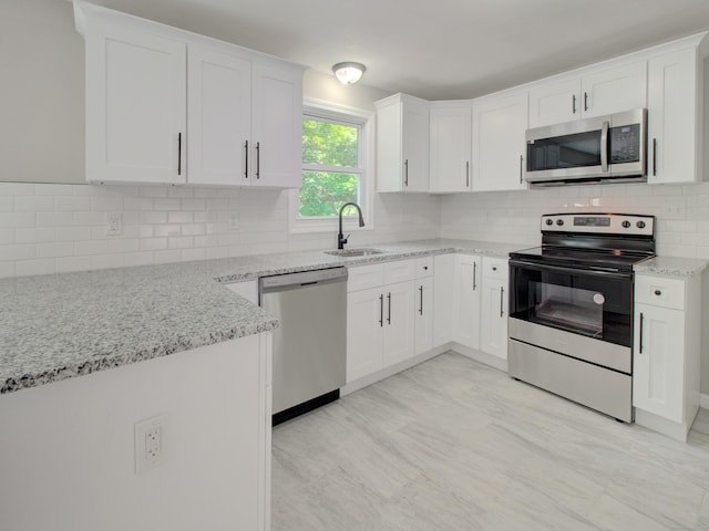 185 Hope Valley Rd, Hebron, CT 06231 - kitchen with appliances with stainless steel finishes, light stone countertops, tasteful backsplash, and white cabinets