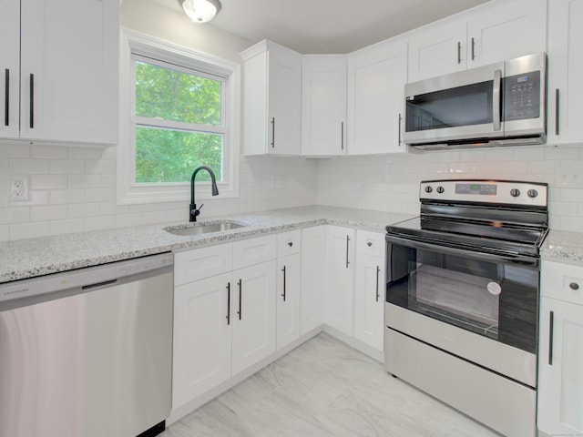 185 Hope Valley Rd, Hebron, CT 06231 - kitchen featuring appliances with stainless steel finishes, light stone countertops, white cabinetry, and backsplash