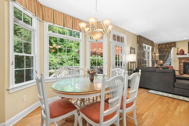 20 Lisbon Ter, Oxford, CT 06478 - dining room with a chandelier, wood finished floors, and a fireplace
