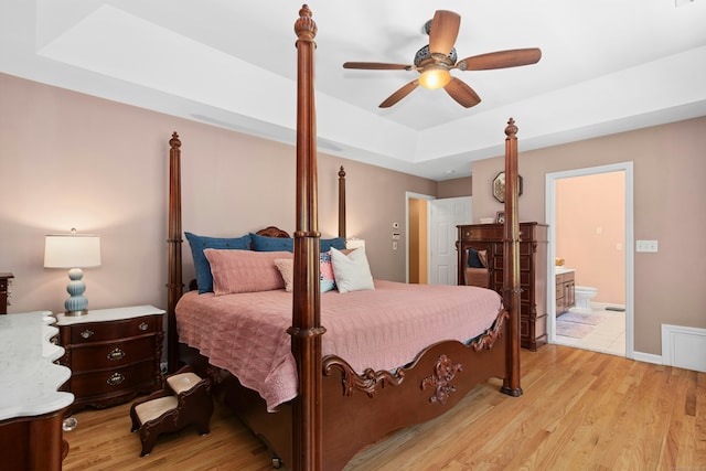 20 Lisbon Ter, Oxford, CT 06478 - bedroom featuring a tray ceiling, light wood finished floors, ensuite bathroom, and ceiling fan
