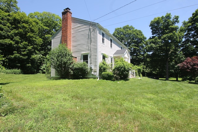 1 Quaker Ridge Rd, Sherman, CT 06784 - view of property exterior with a chimney and a lawn
