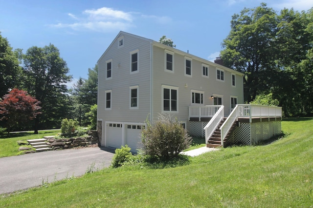 1 Quaker Ridge Rd, Sherman, CT 06784 - rear view of house with stairs, a garage, asphalt driveway, a lawn, and a wooden deck