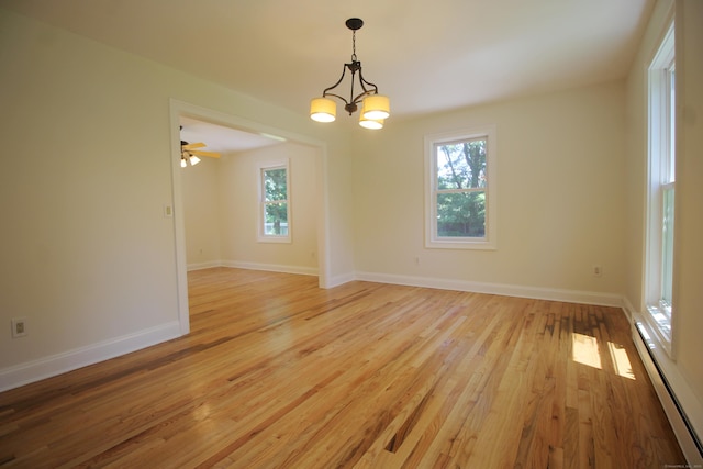 1 Quaker Ridge Rd, Sherman, CT 06784 - spare room featuring a chandelier, a baseboard heating unit, and light wood-type flooring