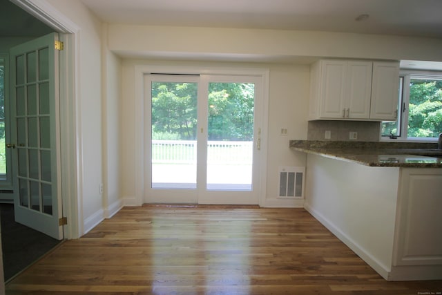1 Quaker Ridge Rd, Sherman, CT 06784 - kitchen featuring wood finished floors, white cabinets, dark stone countertops, and decorative backsplash