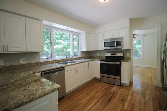 1 Quaker Ridge Rd, Sherman, CT 06784 - kitchen featuring appliances with stainless steel finishes, healthy amount of natural light, white cabinetry, and wood finished floors