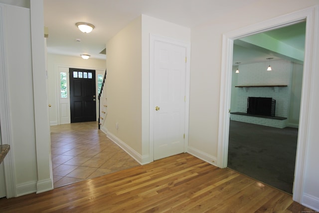 1 Quaker Ridge Rd, Sherman, CT 06784 - foyer with a fireplace, wood finished floors, and stairs