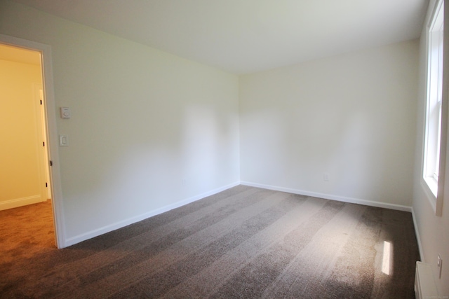 1 Quaker Ridge Rd, Sherman, CT 06784 - empty room with dark carpet and a baseboard radiator