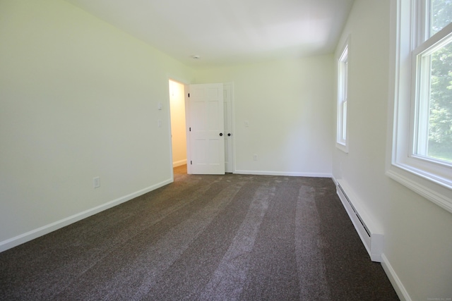 1 Quaker Ridge Rd, Sherman, CT 06784 - empty room featuring a baseboard heating unit and dark colored carpet