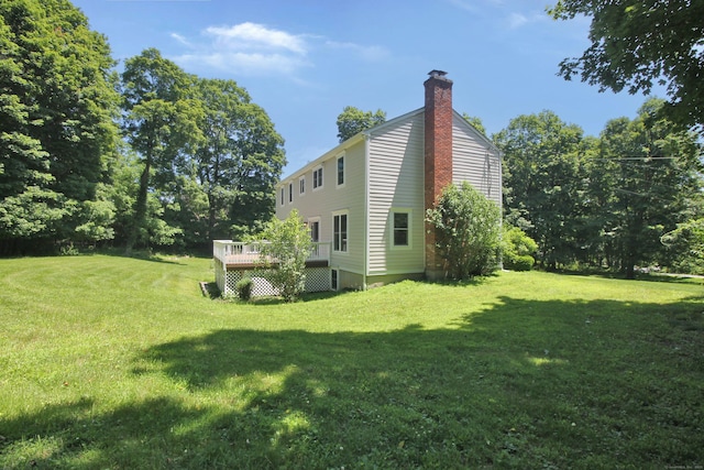 1 Quaker Ridge Rd, Sherman, CT 06784 - view of home's exterior featuring a wooden deck, a yard, and a chimney