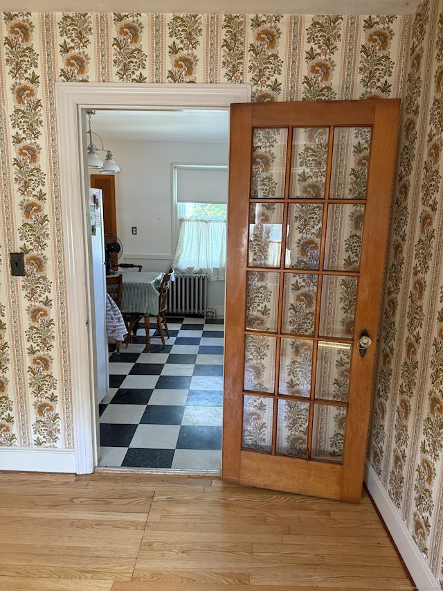 28 Maplerow Ave, Waterbury, CT 06705 - doorway with radiator heating unit and wood finished floors