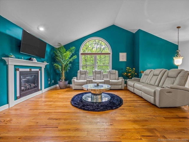 126 Conrad Dr, New Haven, CT 06515 - living room featuring vaulted ceiling, wood finished floors, and a glass covered fireplace