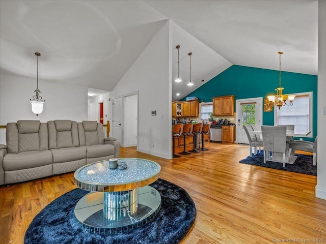 126 Conrad Dr, New Haven, CT 06515 - living room with a chandelier, light wood finished floors, and high vaulted ceiling