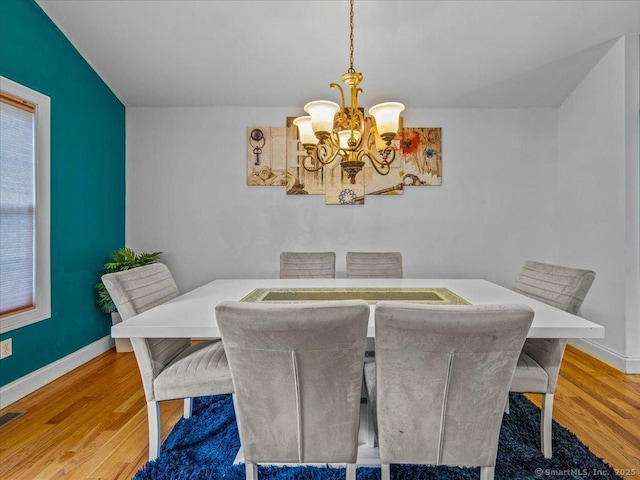 126 Conrad Dr, New Haven, CT 06515 - dining room featuring a chandelier and wood finished floors