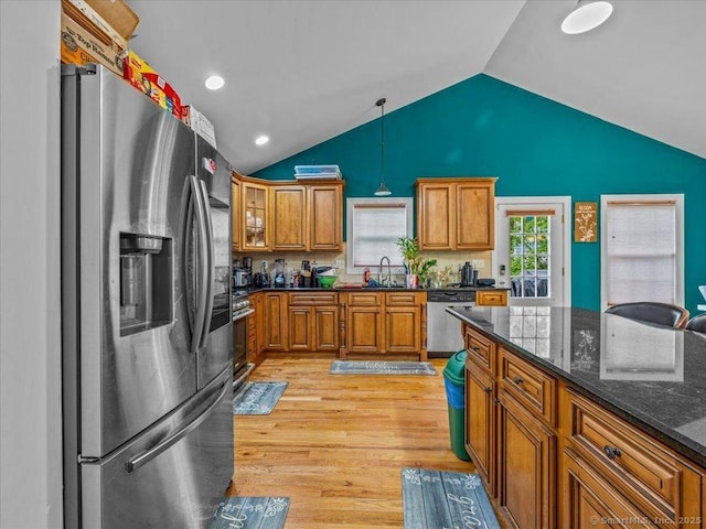 126 Conrad Dr, New Haven, CT 06515 - kitchen featuring stainless steel appliances, brown cabinetry, light wood-style flooring, lofted ceiling, and hanging light fixtures