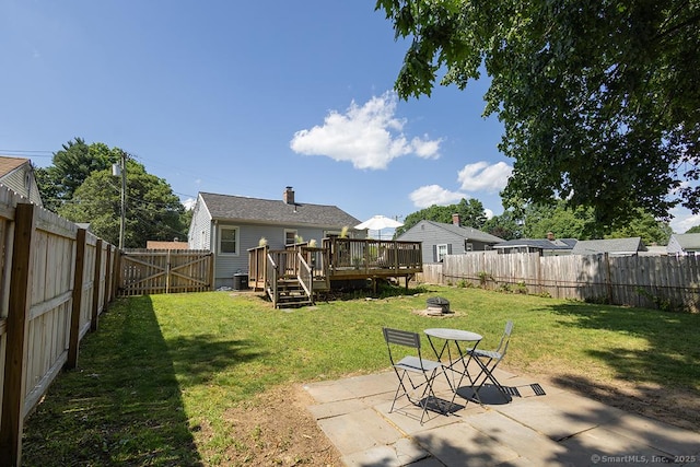 18 Hull Dr, Southington, CT 06479 - fenced backyard featuring a deck, a fire pit, and a patio