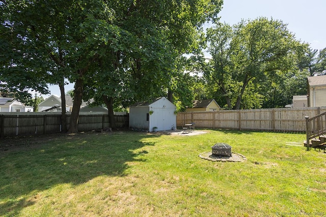 18 Hull Dr, Southington, CT 06479 - fenced backyard with an outdoor fire pit and a storage unit
