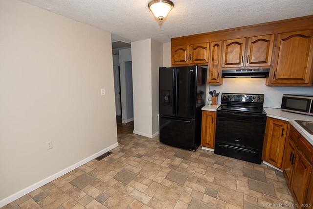 18 Hull Dr, Southington, CT 06479 - kitchen featuring black appliances, under cabinet range hood, light countertops, brown cabinetry, and a textured ceiling